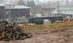 Dover Harbor in the distance.  Pile of Belgian Block pavers from Kemper Street in foreground.  City of Lynchburg public works buildings in the background.